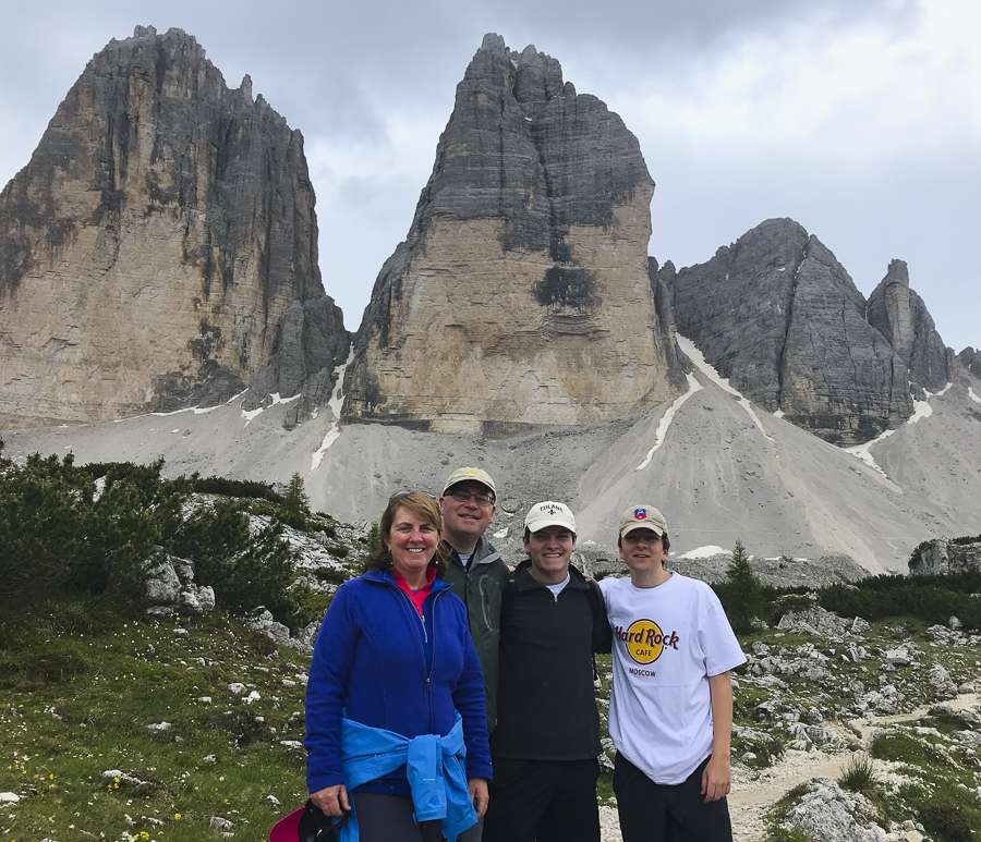 family-dolmites-hike Brent, Missy, and sons posing at the Dolomites in Italy