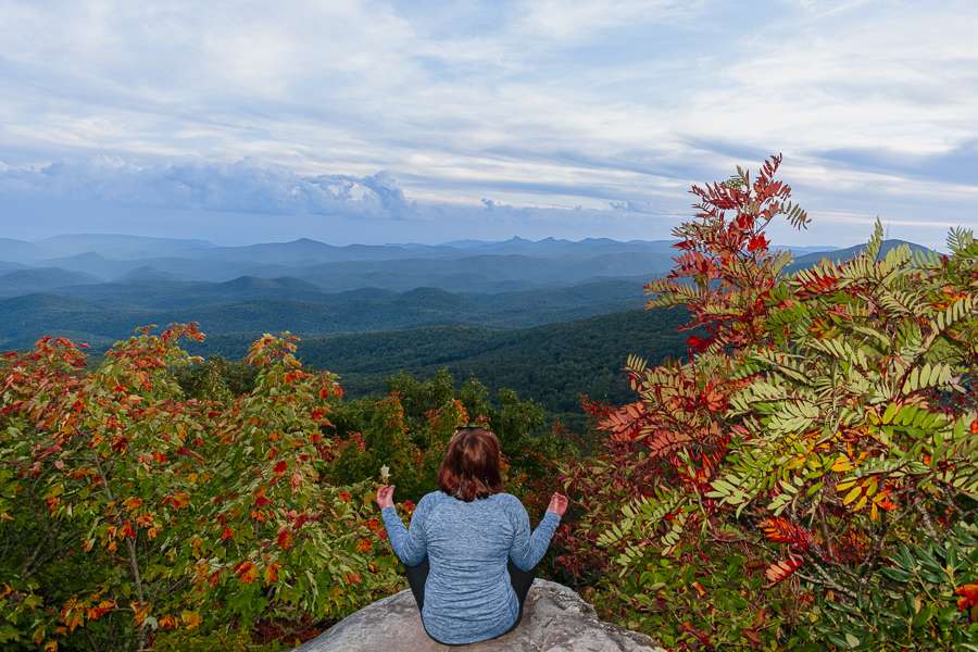 nc-blue-ridge-mountains Missy in a zen pose on rocks among the fall foliage of the Blue Ridge Mountains in NC